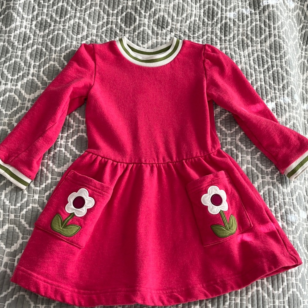 Mini Biden pink spring dress.